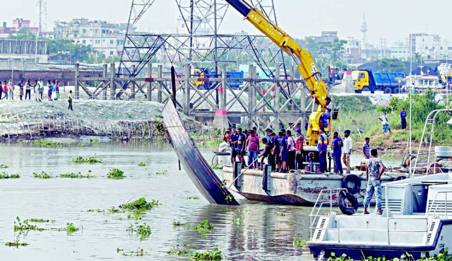 Rescuers conduct operation after a trawler sunk in Turag river on Saturday and recovered five bodies from the water. In another photo, relatives of trawler capsize victims are seen wailing. NN photo