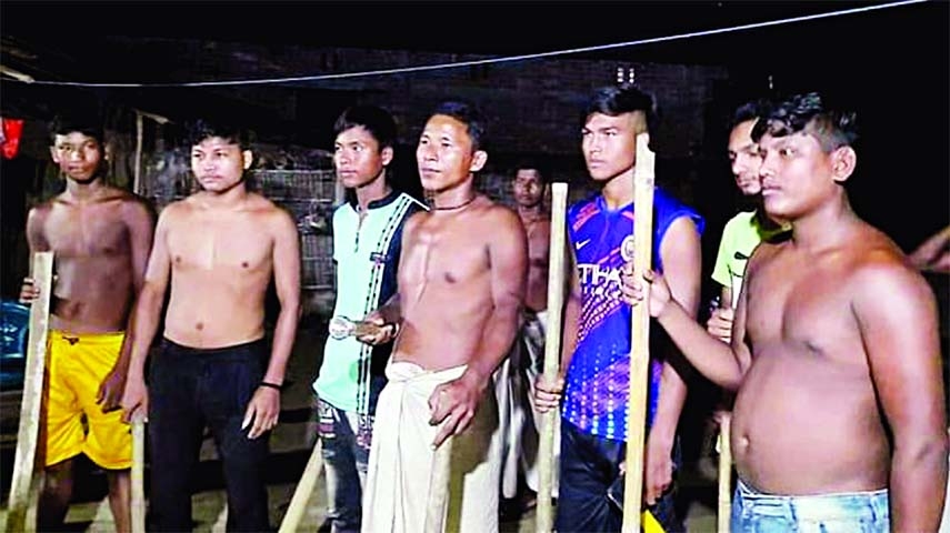 Worried villagers carrying bamboo sticks guard their homes at night at Baliadanga upazila in Thakurgaon district on Saturday in order to prevent thefts.