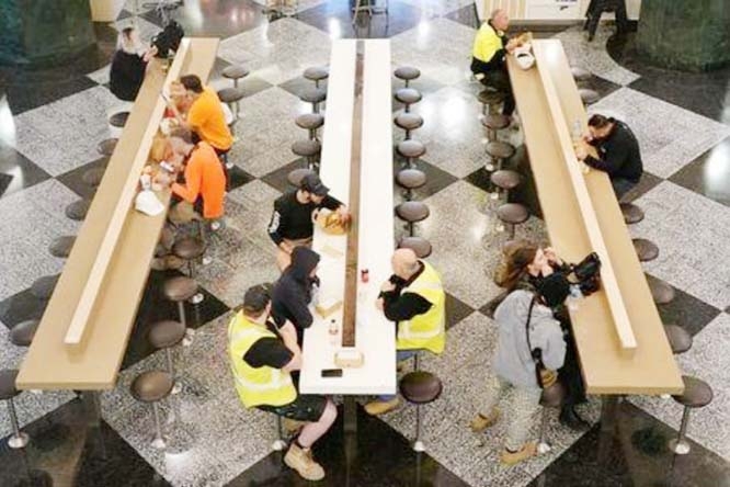 Diners sit to eat at a city centre food court on the first day of eased restrictions for vaccinated patrons, following months of lockdown orders that mandated restaurants only serve take-away and customers couldn't sit to eat at such venues to curb an ou