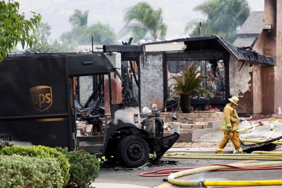 A firefighter walks by the debris of a fatal plane crash on Monday, Oct. 11, 2021 in Santee, California.