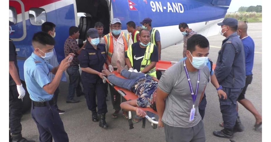 One among many passengers injured in a bus accident in western Nepal's Mugu district is rushed for treatment after being airlifted to Nepalgunj, Nepal, Tuesday, Oct.12, 2021. AP photo