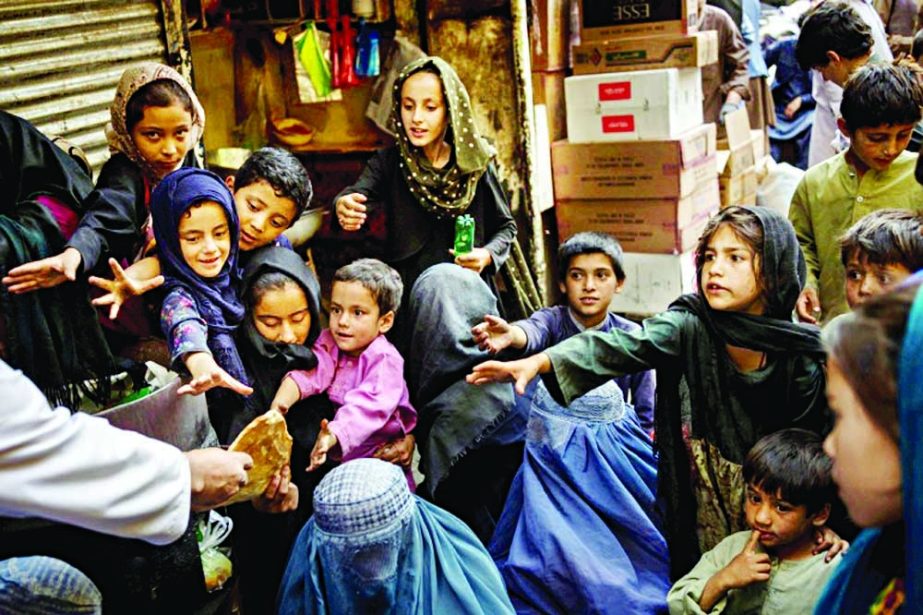 Afghan women and children receive bread donations in Kabul's Old City in this file photo from September. Agency photo