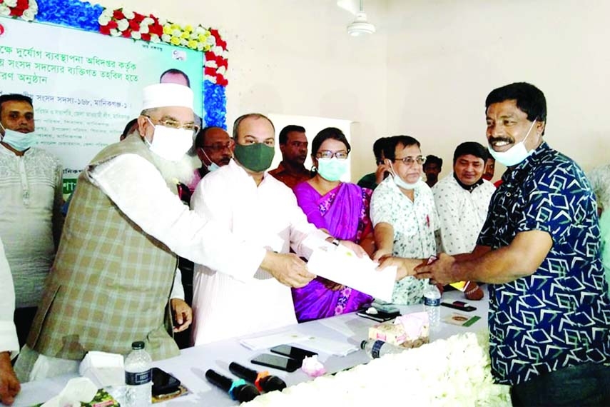 Naimur Rahman Durjoy, MP distributes rice DO and cash as chief guest at the event organized by the Shibalaya Upazila Branch of the Ministry of Disaster Management and Relief at the Upazila Parishad auditorium on Tuesday.