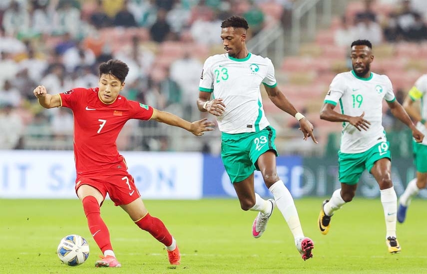 Wu Lei (left) of China competes during the FIFA World Cup Qatar 2022 Asian qualification football match between China and Saudi Arabia in Jeddah, Saudi Arabia on Tuesday.