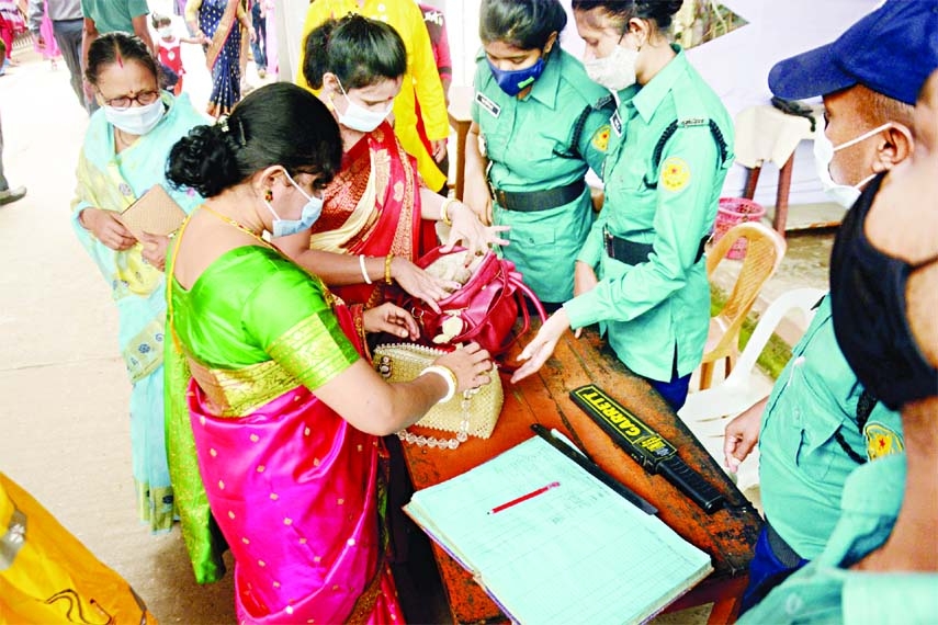 Police personnel check bags of women of the Ram Krishno Mission Mandap on Wednesday as secruity was beefed up for the Durga Puja.