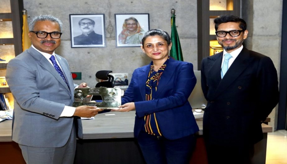 BGMEA president Faruque Hassan handing over a crest to Monica Joshi, Head of Operations for Benetton Asia Pacific Limited, while she visited the BGMEA office on Thursday.