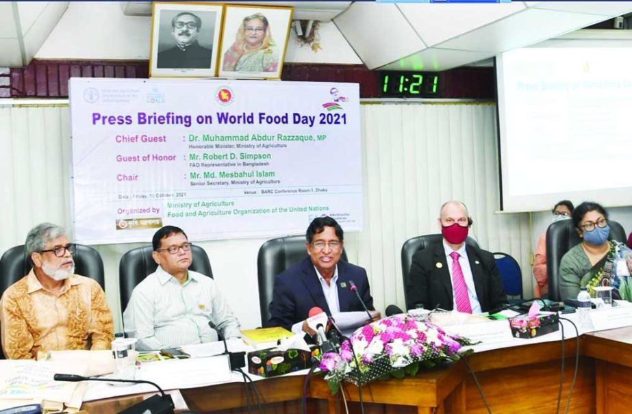 Agriculture Minister Dr Mohammad Abdur Razzaque addressing a press briefing marking World Food Day at Bangladesh Agriculture Research Council at Farmgate in the capital on Friday. Ministry's Senior Secretary Mesbahul Islam and FAO Representative in Bangl
