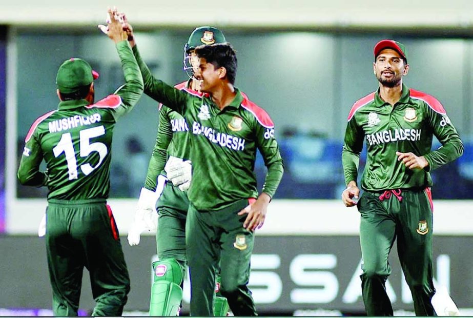 Bangladesh players celebrate the dismissal of a Scotland player during their T20 World Cup first round clash in Muscat Sunday. Agency photo