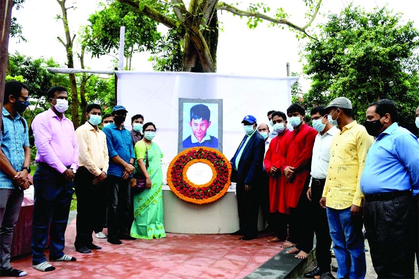 Vice-Chancellor of Begum Rokeya University Prof Dr Md. Hasibur pays tribute to the temporary portrait of Sheikh Russel on the occasion of the 57th birth anniversary of Sheikh Russel, the youngest son of Father of the Nation Bangabandhu Sheikh Mujibur Rahm