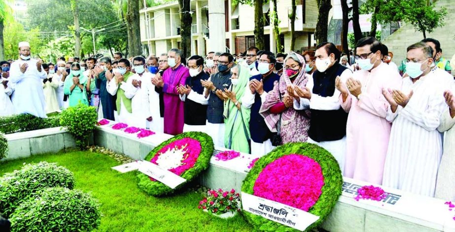 General Secretary of AL and Road Transport and Bridges Minister Obaidul Quader along with others offer munajat after paying floral tributes on the grave of Sheikh Russel in the city's Banani Graveyard on Monday on the occasion of Sheikh Russel Day. NN p