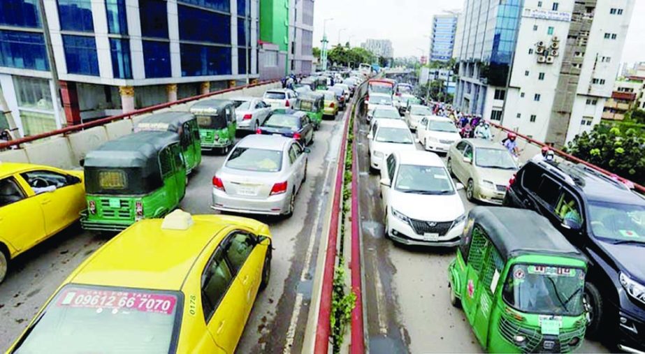 Hundreds of vehicles get clogged in a long tailback on Moghbazar Flyover in the capital on Tuesday ahead of Eid-e-Miladunnabi and weekly holidays. NN photo