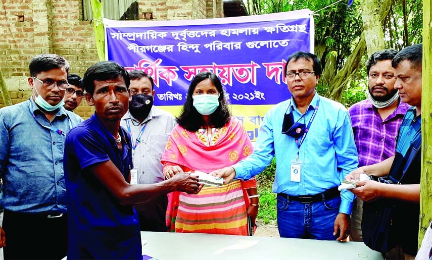 Upazila Nirbahi Officer of Pirganj, Rangpur Biroda Rani Roy on Thursday gives financial assistance to the affected Hindu families who were the victims of recent communal violence. The assistance was provided by a non-governmental development organization.