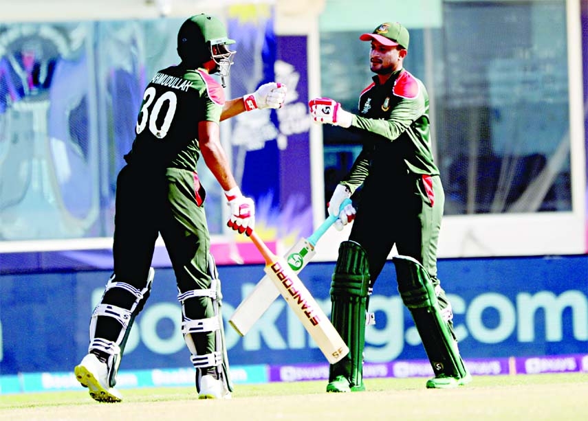 Mahmudullah Riyad (left) and Shakib Al Hasan of Bangladesh toasting each other after Shakib Al Hasan hit a sixer against Papua New Guinea in their last Group-B qualifiers of the ICC T20 World Cup at the Al Amerat Stadium in Oman on Thursday.