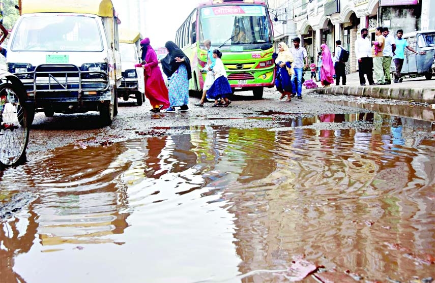 The dilapidated condition of road at Chankhar Pool near Dhaka Medical College in city has caused untold sufferings to commuters and pedestrians as well. This photo was taken on Thursday.