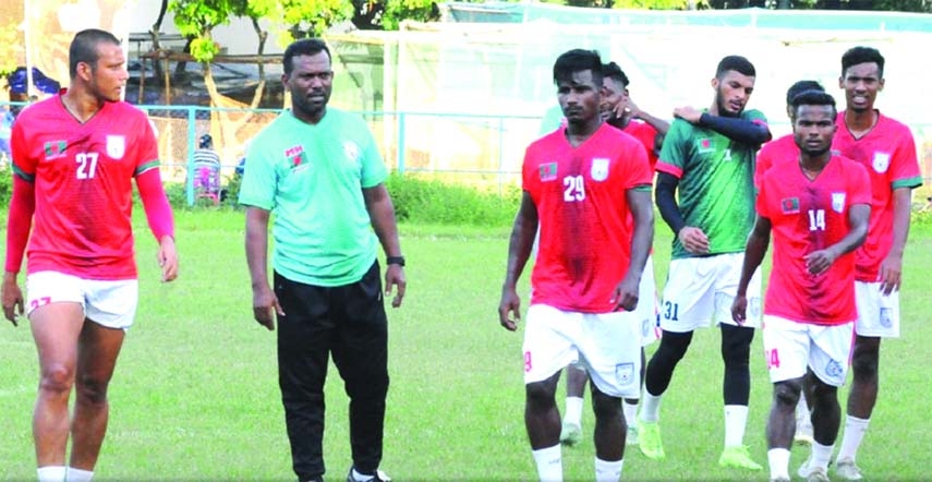 Coach of Bangladesh Under-23 Football team Maruful Haque (second from left) with his boys during their practice session recently.