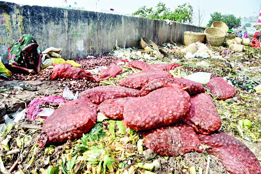 Sacks of rotten onion dumped at Shyambazar area in the capital on Sunday. This indicates either hoarding or poor management of onion stock.