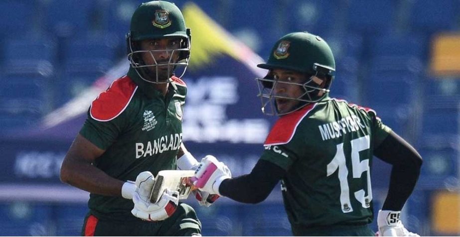 Mahmudullah Riyad (left) and Mushfiqur Rahim of Bangladesh running between the wickets in their Group-1 match of the ICC T20 World Cup against England at Sheikh Zayed Cricket Stadium in the United Arab Emirates on Wednesday. NN photo