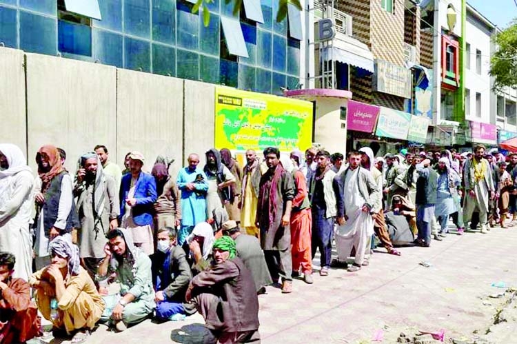 Afghans in capital Kabul line up outside a bank to take out cash.