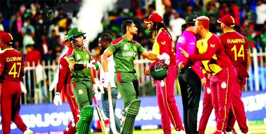 Mahmudullah Riyad (centre) and Afif Hossain of Bangladesh coming out of the crease after an unfortunate three-run loss to West Indies in their third Group-1 match of the ICC T20 World Cup at Sharjah Cricket Stadium in the United Arab Emirates on Friday.