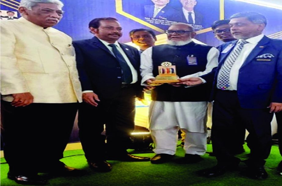 Liberation War Affairs Minister AKM Mozammel Haque gave away 'Rotary Best Service Award' at a function in the capital on Saturday. - NN photo