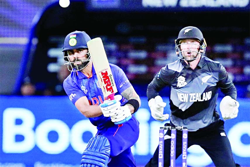 Virat Kohli (left) of India hits a ball, while wicketkeeper Devon Conway of New Zealand looks on during their Group-2 match of the ICC T20 World Cup at Dubai International Stadium in the United Arab Emirates on Sunday.