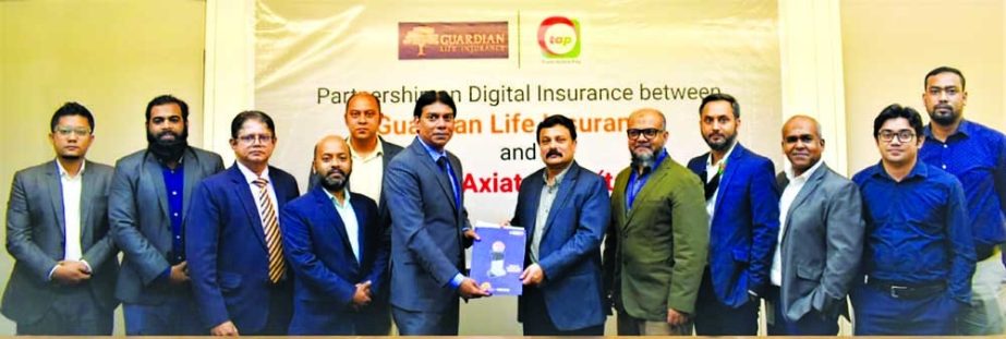 Sheikh Rakibul Karim, Acting CEO of Gurdian Life Insurance Limited and Dewan Nazmul Hasan, Acting CEO of Trust Axiata Pay (tap), exchanging document after signing an agreement in the capital recently. Top executives from both sides were present.