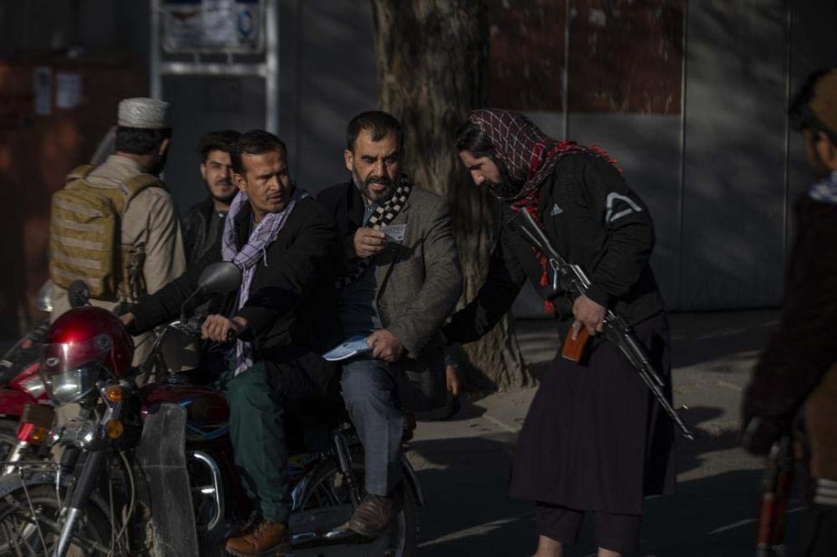 Taliban fighter checks documents after an explosion Tuesday, Nov. 2, 2021. An explosion went off Tuesday at the entrance of a military hospital in Kabul, killing severa; people and wounding over a dozen, health officials said. AP Photo