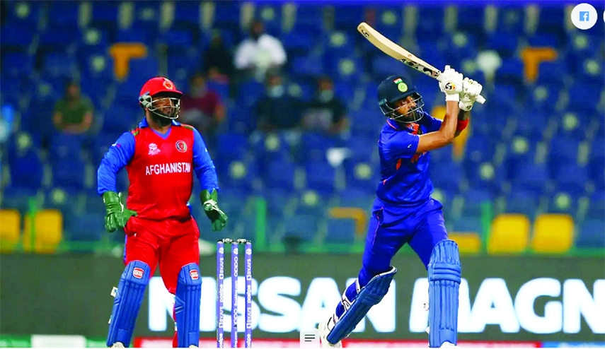 KL Rahul (right) of India drives a ball, while wicketkeeper Mohammad Shahzad of Afghanistan looks on during their Group-2 match of the ICC T20 World Cup at Dubai International Stadium in the United Arab Emirates on Wednesday.