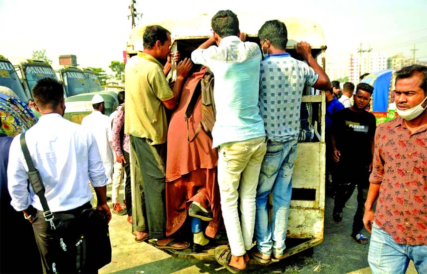 Commuters take a tampu ride on the Dhaka-Chattogram road in the capital as public buses went off road for transport strike on Friday.