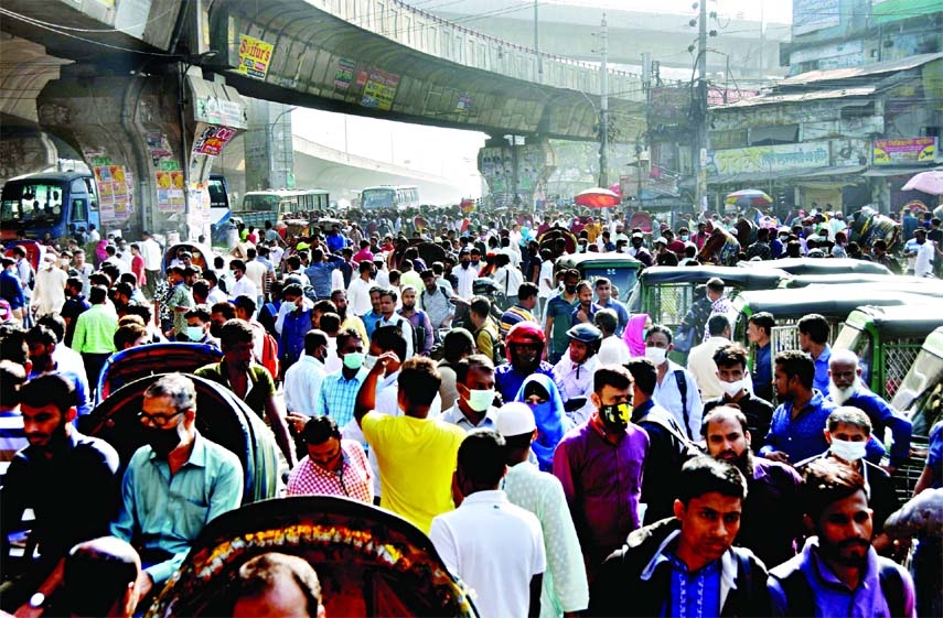 Commuters wait for transports at Jatrabari in the capital to reach their workplaces amid a transport strike on Sunday.