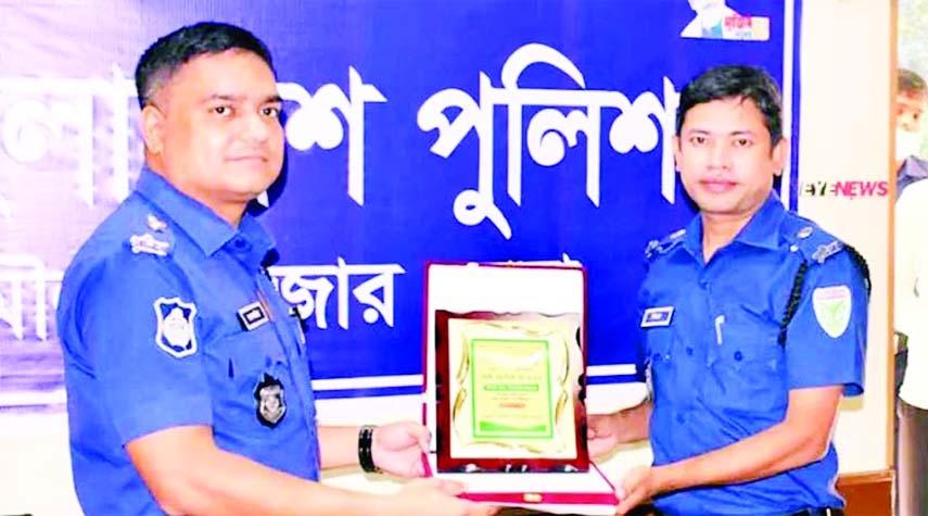 Mohammad Zakariam SP of Moulvibazar hands over a certificate to ASP Moulvibazar Sadar Md Ziayr Rahman as best Sadar Circle Officer of Moulvibazar District on Saturday.