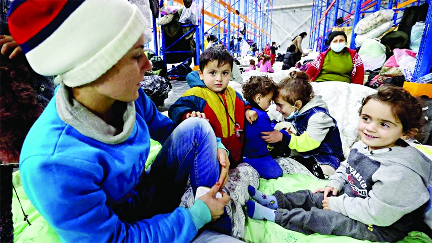 Migrant children settle for the night in the logistics center in the checkpoint "Kuznitsa" at the Belarus-Poland border near Grodno, Belarus, on Wednesday.