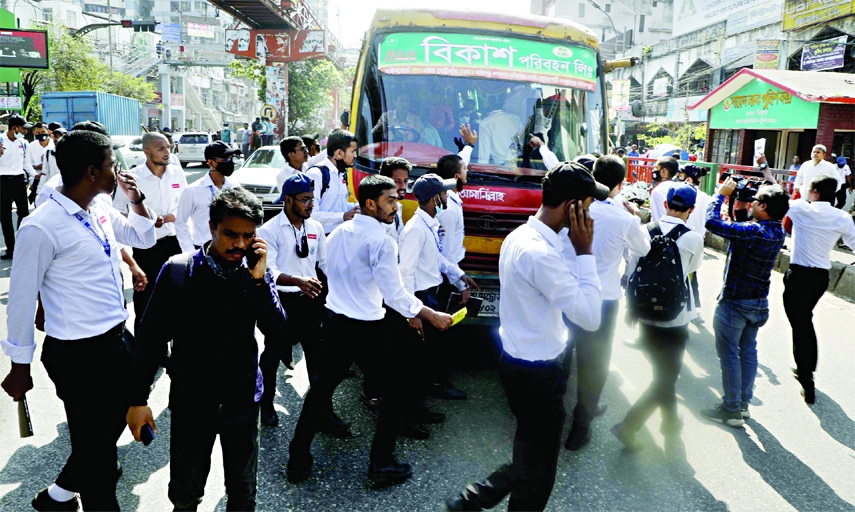 Students of Dhaka College take to the street near New Market in the capital on Thursday demanding concession of bus fares.