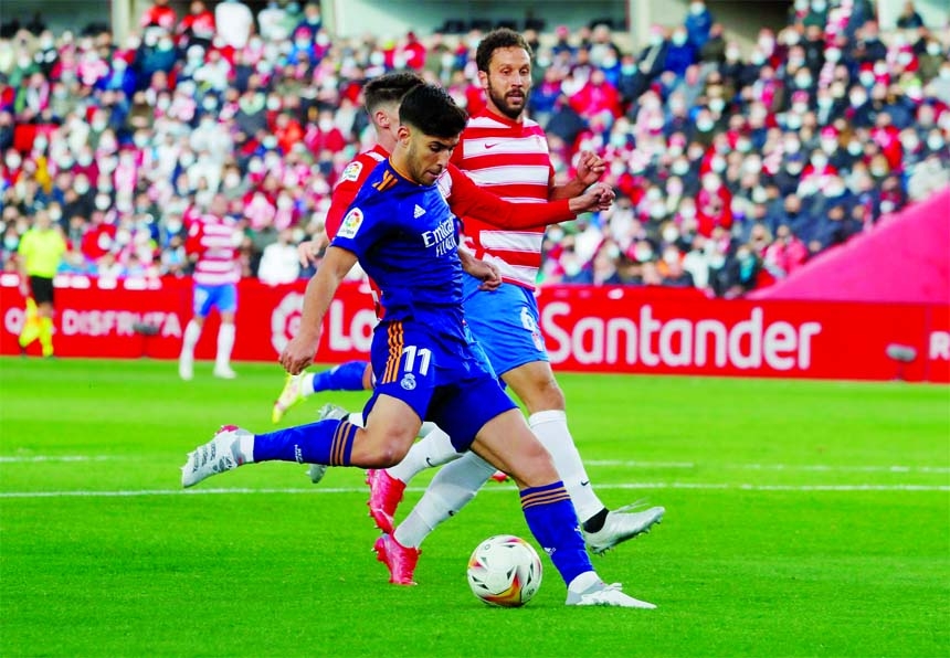 Real Madrid's Marco Asensio (front) opens the scoring during their LaLiga match away to Granada on Sunday.