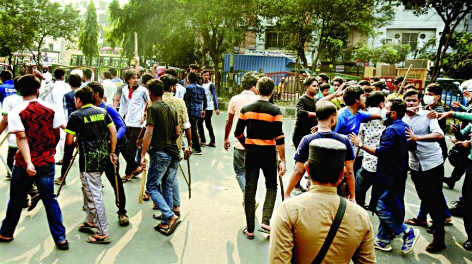 A group of students from Dhaka College attack student protesters during a demonstration demanding that they be allowed to pay half the bus fares at Science Laboratory intersection on Tuesday. NN photo