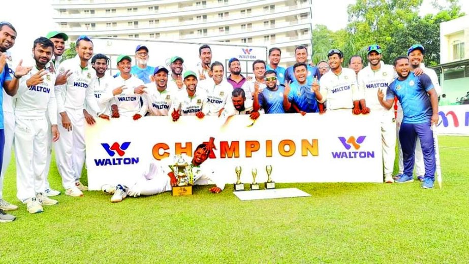 Dhaka Division's cricketers pose with the Bangabandhu National Cricket League (NCL) trophy at BKSP-3 ground on Wednesday. Agency photo