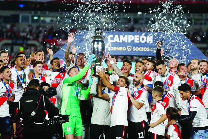 Members of River Plate celebrating with the trophy after beating Racing Club in their Argentina Primera Division Football League match at Estadio Monumental in Buenos Aires, Argentina on Thursday.