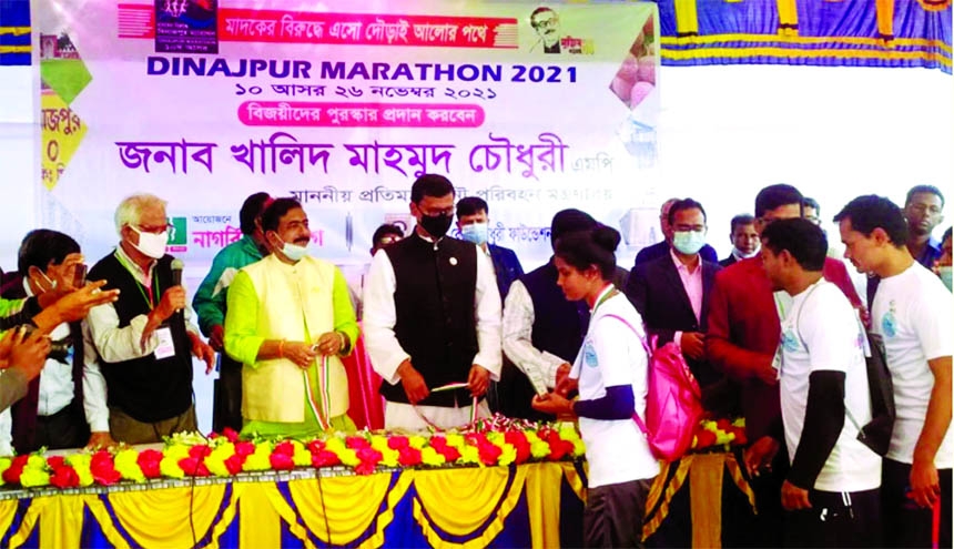 State Minister for Shipping Khalid Mahmud Chowdhury distributes prizes among the winners of the tenth Dinajpur Marathon Competition on Kantoji temple premises at Kaharol in Dinajpur on Friday.