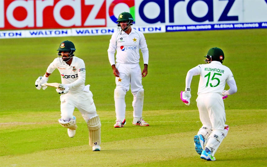 Liton Das (left) and Mushfiqur Rahim (right) of Bangladesh running between the wickets against Pakistan on the first day of the first Test at the Zahur Ahmed Chowdhury Stadium in Chattogram on Friday. Liton Das scores unbeaten maiden century.