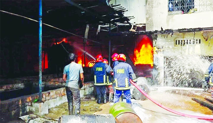 Fire Service officials at work to douse the fire at a chemical factory in the BSCIC Industrial area in Chattogram's Sagarika on Friday.