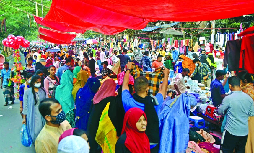Buyers crowd at a Holiday Market near the Motijheel Ideal School in the capital on Friday.