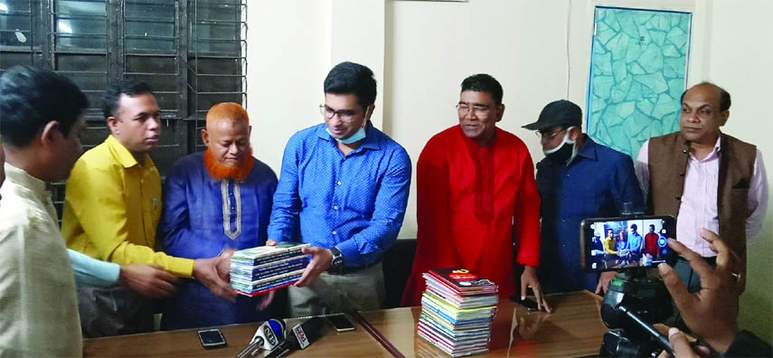 MADHUKHALI (Faridpur): Poet Shahid Biplob, Publisher of Tai Tai Publication presenting books for Madhukhala Public Library to Md Ashiquer Rahman Chowdhury, UNO, Madhukhali Upazila and President of the library recently.