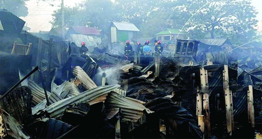 Fire-fighters trying to douse flames at a slum beside Sena Kalyan Bhaban in Tongi, Gazipur on Saturday inducing more than 200 shanties gutted.