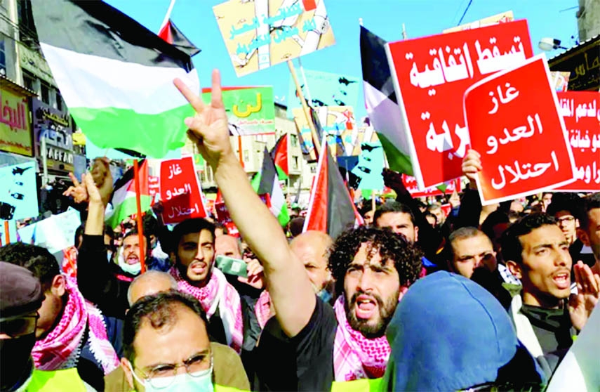 Jordanians carry flags and placards as they demonstrate against the declaration of intent for water-for-energy deal in downtown Amman on Friday.