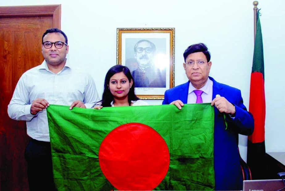 Lobuche mountain conqueror of the first woman in Bangladesh Joynab Bine Hossain Shanto gives the flag hoisted on mountain peaks to Foreign Minister Dr AK Abdul Momen as gift at Pororastro Bhaban in the capital on Sunday. NN photo