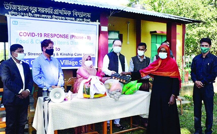 Sylhet: Balaganj Upazila Nirbahi Officer Rozina Akter distributes food items among under privilege people of the locality under the initiatives of SOS Shishu Palli Sylhet recently.