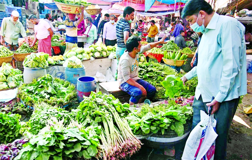 People throng Karwan Bazar in the capital on Friday. Though seasonal vegetables were abundant in the weekly market, there was little customers pressure due to exorbitant price.