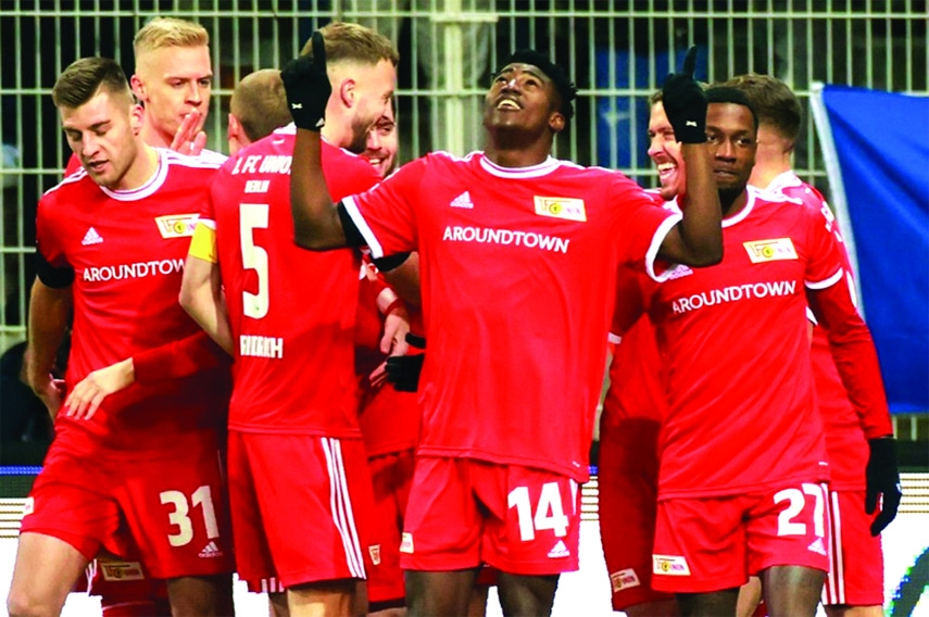 Union Berlin's Taiwo Awoniyi (3rd right) celebrates scoring the opening goal against RB Leipzig during the German first division Bundesliga football match in Berlin on Friday.