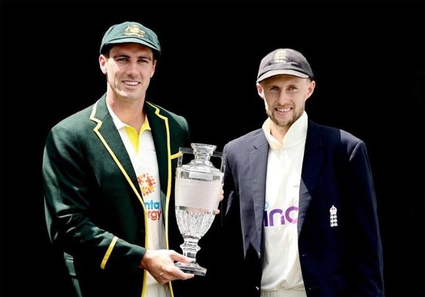 Australia's new captain Patrick Cummins (left) and England's captain Joe Root (right) pose with the Ashes trophy at the Gabba in Brisbane on Sunday.
