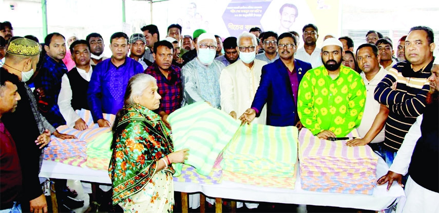 KHULNA : Khulna City Corporation Mayor Talukder Abdul Khaleque distributes winter clothes among the poor people at Party Office of Khulna City Unit Jubo League on the occasion of Sheikh Fazlul Haque Moni's birthday on Saturday.